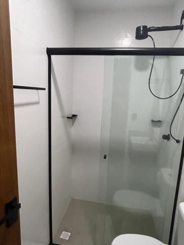 a shower stall with a toilet in a bathroom at Pousada do Francês in Ubatuba