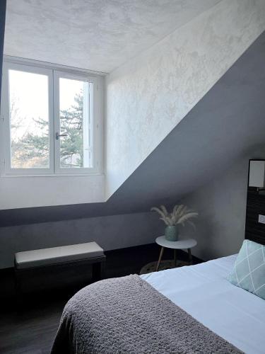 a bedroom with a bed and a window at Les Olivades in Gap