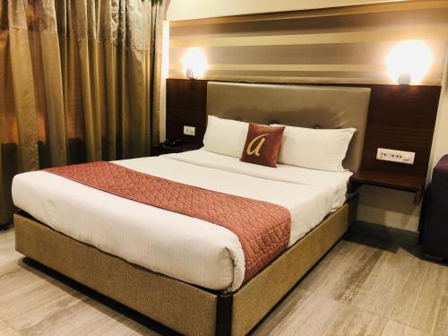 a hotel room with a bed with a pillow on it at Astra Hotels & Suites - Kadubeesanahalli ,Opposite Oracle and JP Morgan, Marathahalli Outer Ring Road in Bengaluru