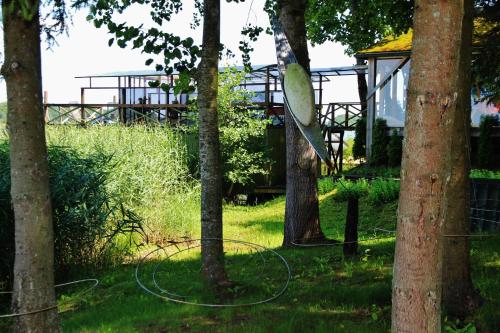 a gazebo in the middle of a park with trees at Sodyba Brazylija in Taraldžiai