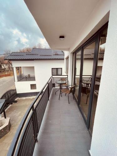 a balcony with a table and chairs on a building at Casa YDA in Horezu