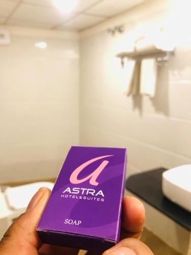 a person holding a purple box of asian toothpaste at Astra Hotels & Suites - Kadubeesanahalli ,Opposite Oracle and JP Morgan, Marathahalli Outer Ring Road in Bengaluru