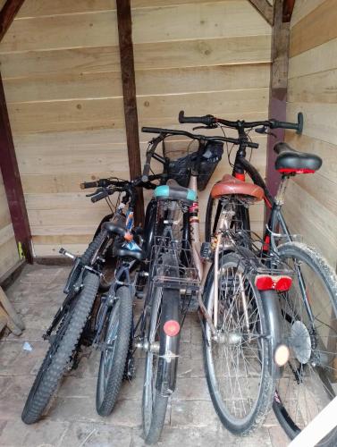 a group of three bikes parked in a garage at Apartman Dve lipe in Palić