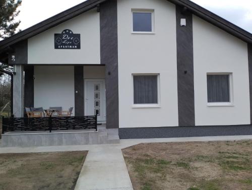 a house with a black and white facade at Apartman Dve lipe in Palić