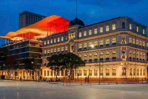 a large building is lit up at night at Loft Vista dos Arcos in Rio de Janeiro