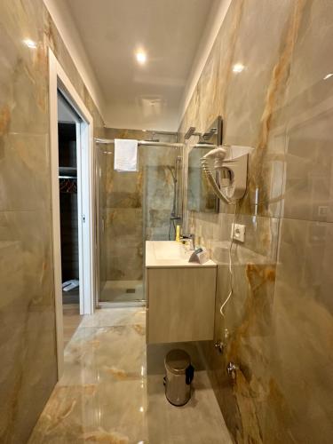 a bathroom with a sink and a shower at Sunset Guest House in Reggio Calabria