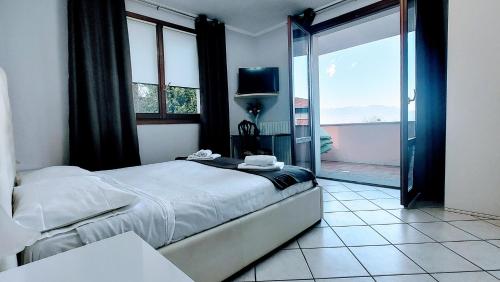 a bedroom with a bed and a sliding glass door at B&B Madonna della Neve in Stresa