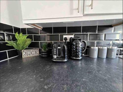 a kitchen counter with a coffee maker on a counter top at Spacious One-Bedroom in St. Helens in Burtonwood