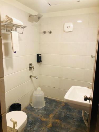a bathroom with a toilet and a sink at Astra Hotels & Suites - Kadubeesanahalli ,Opposite Oracle and JP Morgan, Marathahalli Outer Ring Road in Bengaluru