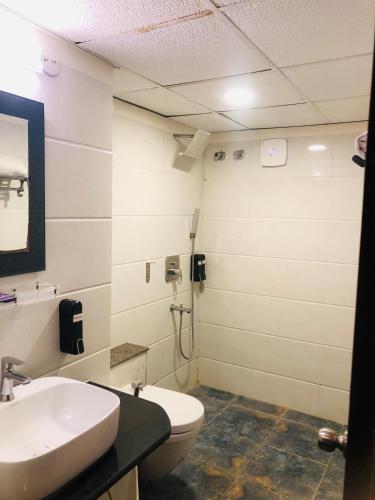 a bathroom with a sink and a toilet at Astra Hotels & Suites - Kadubeesanahalli ,Opposite Oracle and JP Morgan, Marathahalli Outer Ring Road in Bengaluru