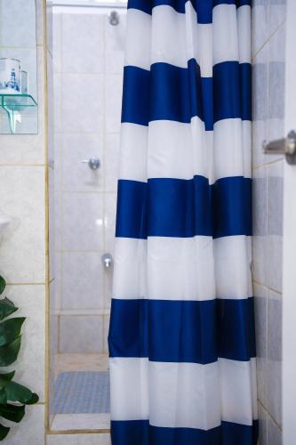 a blue and white shower curtain in a bathroom at The ARC in Scarborough