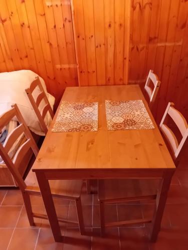 a wooden table and chairs in a room at Monolocale terminillo in Rieti