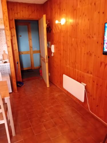 a room with wooden walls and a tiled floor at Monolocale terminillo in Rieti