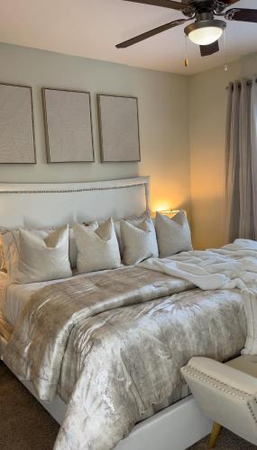 a large bed in a bedroom with a ceiling fan at Atlanta Beltline Luxury Suite in Atlanta