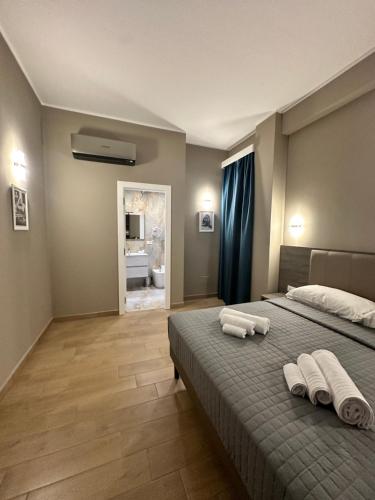 a bedroom with a bed with two towels on it at Sunset Guest House in Reggio di Calabria