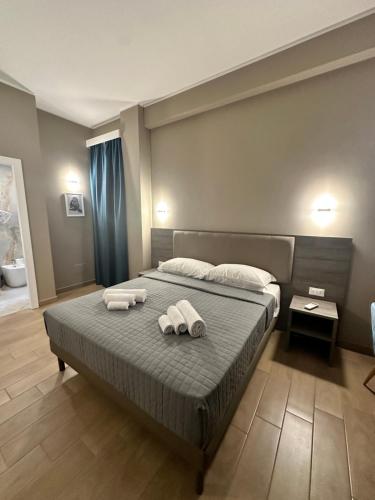 a bedroom with a bed with towels on it at Sunset Guest House in Reggio Calabria