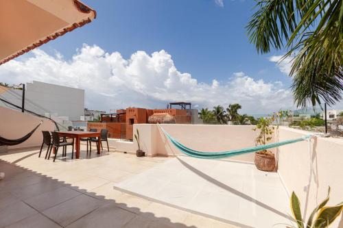 a hammock on the roof of a house at Via Tendenza Condos in Playa del Carmen