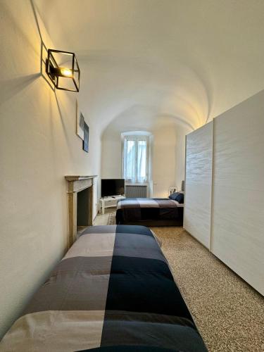 a hotel room with two beds and a fireplace at Giulivi Assisi Apartments in Assisi