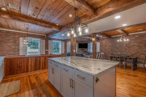 an open kitchen and dining room with wooden ceilings at The Loft on Trade Street in Tryon