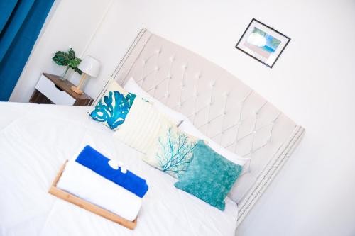 a bedroom with a white bed with pillows on it at The ARC in Scarborough