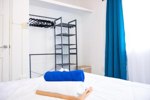 a bed with a blue pillow on top of it at The ARC in Scarborough