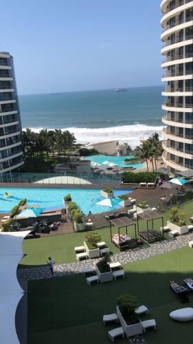 a view of a resort with a swimming pool and the beach at Iconic Pearls of Umhlanga in Durban