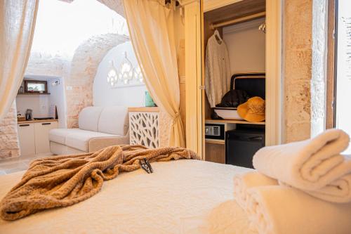 a bedroom with a bed with a towel on it at B&B TRULLI MIRIVA' in Alberobello