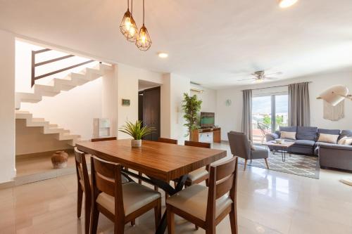 a dining room and living room with a table and chairs at Via Tendenza Condos in Playa del Carmen