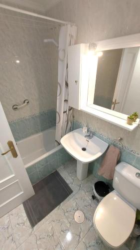 a bathroom with a sink and a toilet and a shower at Alba Apartman Torrevieja in Torrevieja