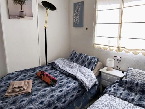 a bedroom with a bed with a toy car on it at Alba Apartman Torrevieja in Torrevieja