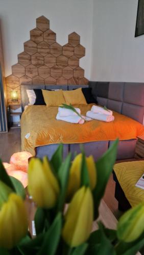 a bedroom with a bed with towels on it at Underground Cave Apartment in Wieliczka
