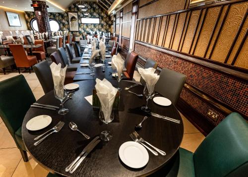 a dining room with a long table and chairs at Ballymac Hotel in Stonyford