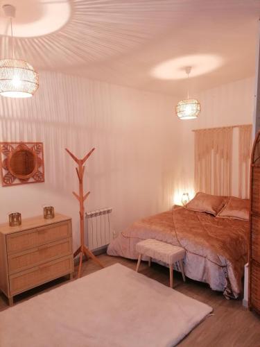 a bedroom with a bed and a dresser and lights at L'orientale in Rouvroy