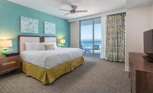 a bedroom with a bed with a view of the ocean at Club Wyndham Clearwater Beach Resort in Clearwater Beach