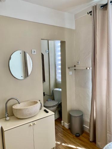 a bathroom with a sink and a toilet and a mirror at Operappart 2 in Toulon