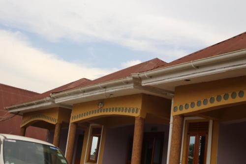 a house with awning on the front of it at DAR Guest House in Kabarole