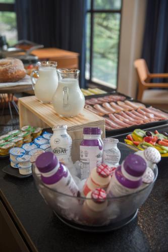 a table topped with a bowl of eggs and food at Pinot Hotel in Campos do Jordão
