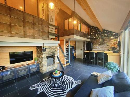 a living room with a couch and a fireplace at Woody Lodge - Duplex Nature Bonsoy Ardennes in Hastière-par-delà