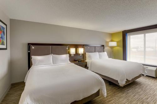 a hotel room with two beds and a window at Holiday Inn Express Hotel & Suites Bryan-Montpelier by IHG in Holiday City