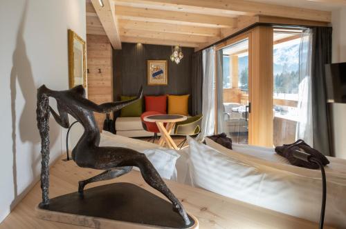 a statue of a woman on a table in a room at Locanda degli Artisti Art Hotel in Canazei