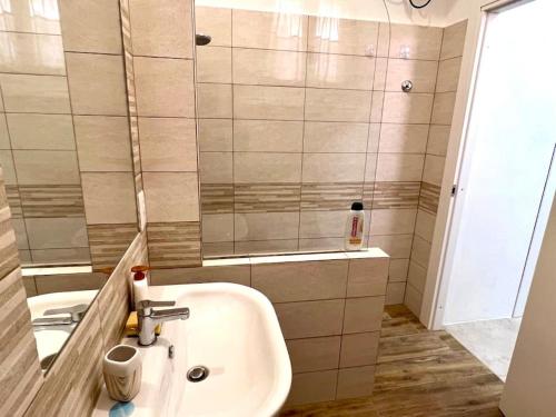 a bathroom with a sink and a shower at Sardegna - a due passi dal mare in Porto Pozzo