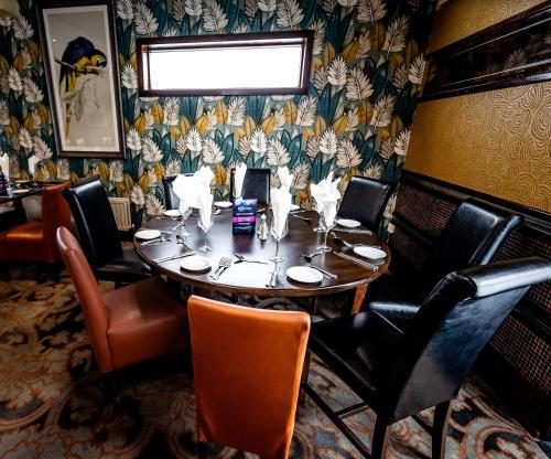 a dining room with a table in a restaurant at Ballymac Hotel in Stonyford