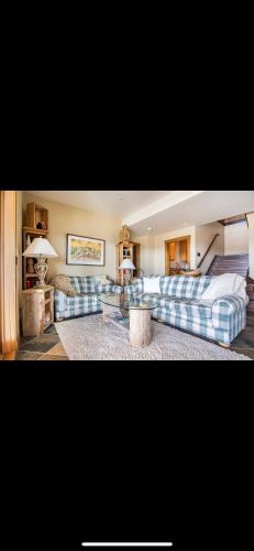 a living room with two couches and a couch at Heart West Haven in Priddis