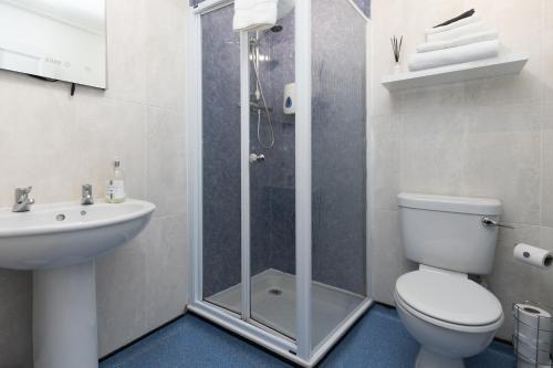 a bathroom with a shower and a toilet and a sink at Stornoway Bed and Breakfast in Stornoway