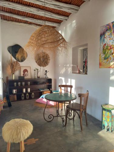 a room with a table and chairs and a ceiling at Les jardins de Silona in Essaouira