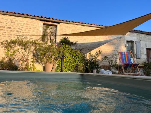 une piscine devant une maison dans l'établissement Le Cottage, à Foussignac