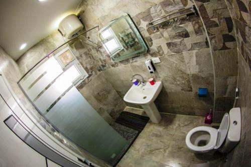 a bathroom with a shower and a toilet and a sink at Ryan Apartments in Hurghada