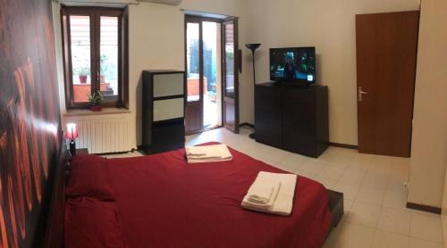 1 dormitorio con cama roja y TV en Garden Wine Suite, en Verona