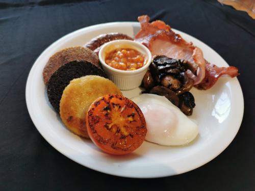 a plate of breakfast food with eggs and other foods at Stornoway Bed and Breakfast in Stornoway