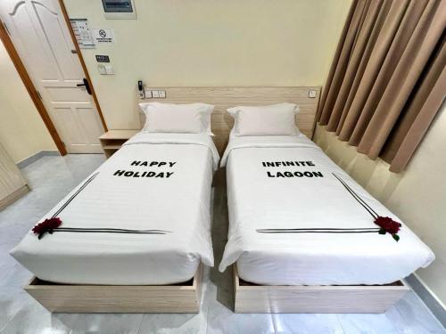 two beds sitting next to each other in a room at INFINITE LAGOON in Mandhoo